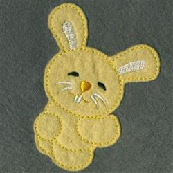 Applique bunny in soft yellow felt with white embroidered details and an orange nose, perfect for Easter decor.