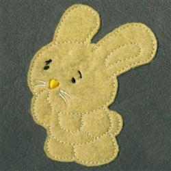 Applique rabbit in soft pastel yellow felt with a thoughtful expression and whimsical design, perfect for Easter.