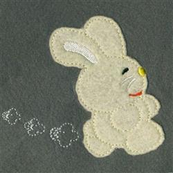 Applique rabbit with cheerful smile and yellow nose, hopping against a dark gray background, perfect for spring.