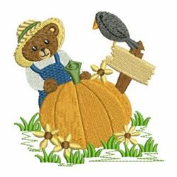 Applique bear in a straw hat and blue overalls leans against an orange pumpkin in a colorful fall scene.