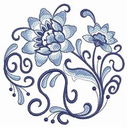 Intricate floral embroidery featuring blue flowers and swirling vines, creating an elegant, detailed design.