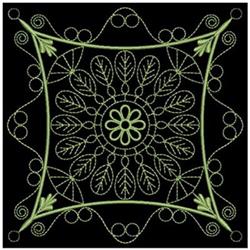 Elegant decorative floral design with intricate swirls and leaves in soft green on black, perfect for quilting.