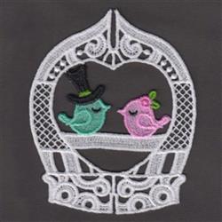 FSL design featuring two whimsical birds in a lace frame; one green with a top hat, the other pink with flowers.