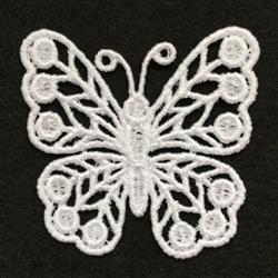 FSL butterfly in delicate white lace with intricate symmetry, showcasing fine details against a dark background.