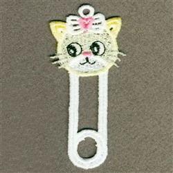 FSL cat face with large eyes and a pink bow, integrated into a safety pin shape, in playful style.