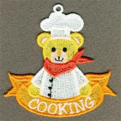 FSL bear in chef's attire with a white hat and red scarf, smiling under a bright yellow 'COOKING' banner.