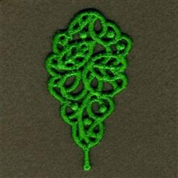 FSL decorative lace featuring intricate green leaf motifs on a dark background with detailed loops and swirls.