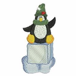 Colorful applique penguin with a green hat and scarf sitting on a light blue ice block, perfect for whimsical winter decor.