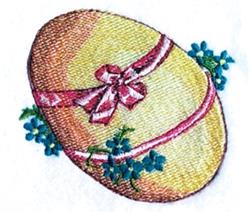 Colorful Easter egg with glossy yellow finish, adorned with pink ribbon and blue flowers, perfect for festive spring decor.