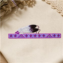 Vibrant embroidery featuring two feathers in white and dark brown within a geometric border of purple and pink.