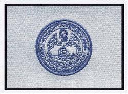 Circular emblem in rich blue thread, featuring detailed geometric patterns on light gray fabric with a dark border.