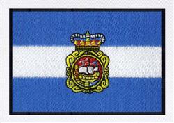Vibrant flag with emblem featuring a ship and crown on a blue background, detailed white stripe.