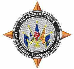 Military emblem patch featuring a black circular border and silver inner circle, with colored flags and compass points.