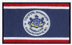 Embroidery patch featuring a circular state emblem on navy blue fabric, framed by red and white stripes, providing a formal a