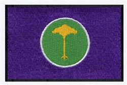 Vibrant embroidery badge featuring a tree emblem with a yellow design on a green circle and purple background.