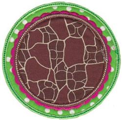 Applique circular patch with a textured brown center, pink scalloped border, and green polka dot background.
