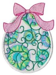 Applique decorative egg featuring vibrant floral patterns and green vines, topped with a pink bow for Easter.