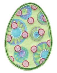 Applique decorative egg with colorful circular patterns on a vibrant green background, perfect for Easter.