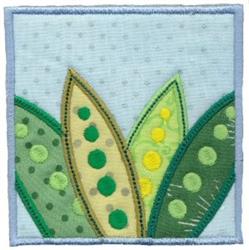 Applique design featuring vibrant green and yellow leaves with playful polka dots on a light blue background.