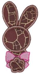 Applique bunny head with large ears, cracked brown texture, and pink bow with flower shape, perfect for Easter.
