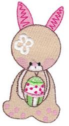 Playful bunny with pink ears holding a decorated Easter egg with floral detail, perfect for springtime festivities.