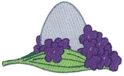 Decorative egg featuring a light blue tone with vibrant purple flowers and green leaves, perfect for spring Easter decor.