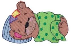 Applique sleeping bear nestled under a green polka-dot blanket, wearing a blue nightcap with a playful expression.