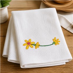Colorful yellow flowers with green stems on white towels, creating a cheerful and playful home decor design.
