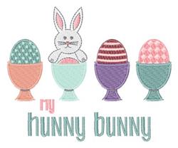 Playful bunny with large ears next to colorful decorated eggs for Easter, featuring the text 'my hunny bunny'.