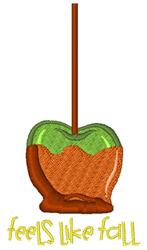 Playful candy apple with glossy green coating and textured brown caramel, featuring 'feels like fall' text.