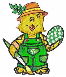 Colorful chick in green overalls and straw hat, holding a paintbrush and decorated egg for Easter.