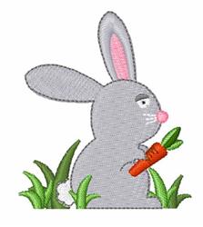 Cute gray rabbit with large pink ears holds a bright orange carrot in green grass, perfect for playful Easter designs.