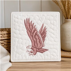 Realistic hawk in dusty rose with outstretched wings on quilted white background for modern home decor.