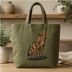 Applique green tote bag featuring a detailed howling wolf in brown and black against a textured background.