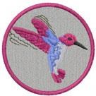 Colorful hummingbird in mid-flight with pink and blue hues, surrounded by a vibrant pink border.