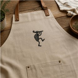 Whimsical mouse playing a flute on a cream apron with rustic brown leather straps, perfect for casual wear.