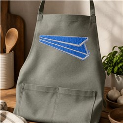 Grey apron featuring a blue paper airplane embroidered on the front, set in a cozy kitchen with wooden utensils.