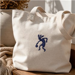 Tote bag in light beige fabric featuring playful blue embroidery. Modern and simple design suitable for casual use.