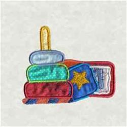Applique stack of colorful books with red, blue, green, and yellow blocks, featuring a playful handle on top.