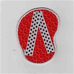 Applique bean shape with vibrant red texture, bold white 'A' with black polka dots on a bright background.