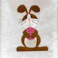 Playful bunny with brown fur and pink details, holding a polka-dotted Easter egg for festive designs.