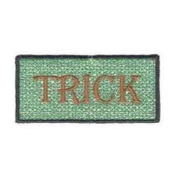 FSL text patch with a light green background, brown 'TRICK' text, and black outline for Halloween decor.