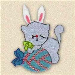 Cute gray cat with bunny ears sits on colorful yarn ball, holding a green bow for Easter celebrations.