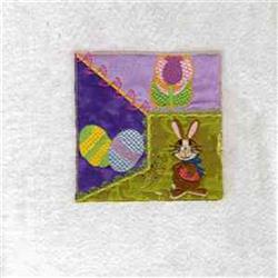 Colorful rabbit with a basket among Easter eggs and flowers, perfect for festive quilting designs.
