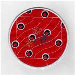 Red circular patch featuring playful black circles and decorative stitching against a vibrant backdrop.