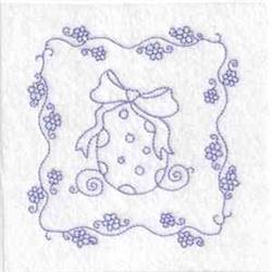 Redwork decorative egg with polka dots and a bow, surrounded by floral elements for a whimsical Easter theme.