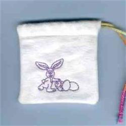 Redwork rabbit alongside colorful Easter eggs on a white pouch with purple embroidery and a playful drawstring.