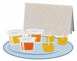Colorful appetizers on a round plate with vibrant yellow pieces and orange sauce cups, accented by a light napkin.