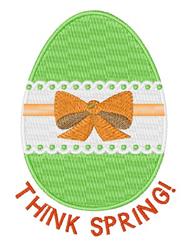 Easter egg in vibrant green adorned with an orange bow and white stripe with green dots, celebrating spring.