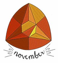 Geometric autumn leaf design in orange and yellow, featuring 'november' in a playful handwritten style.
